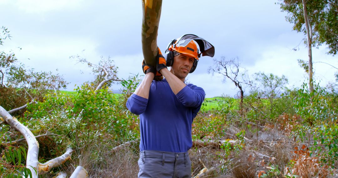 Lumberjack Carrying Large Tree Log in Forest