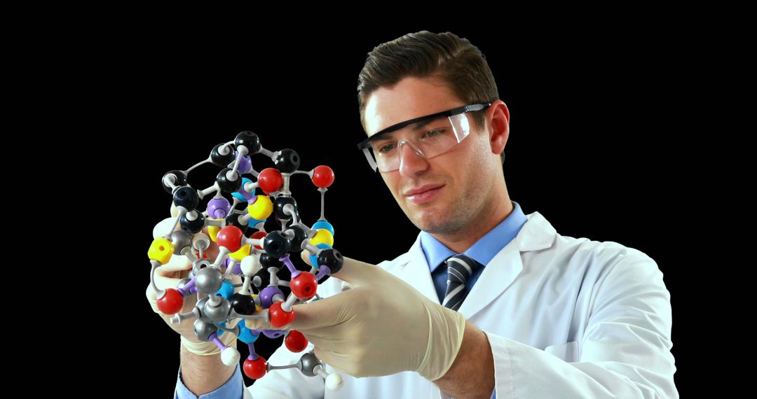 Scientist Examining Molecular Model against Black Background - Free Images, Stock Photos and Pictures on Pikwizard.com