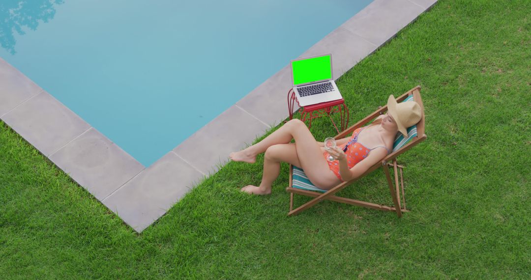 Woman Relaxing by Swimming Pool with Laptop and Drink - Free Images, Stock Photos and Pictures on Pikwizard.com