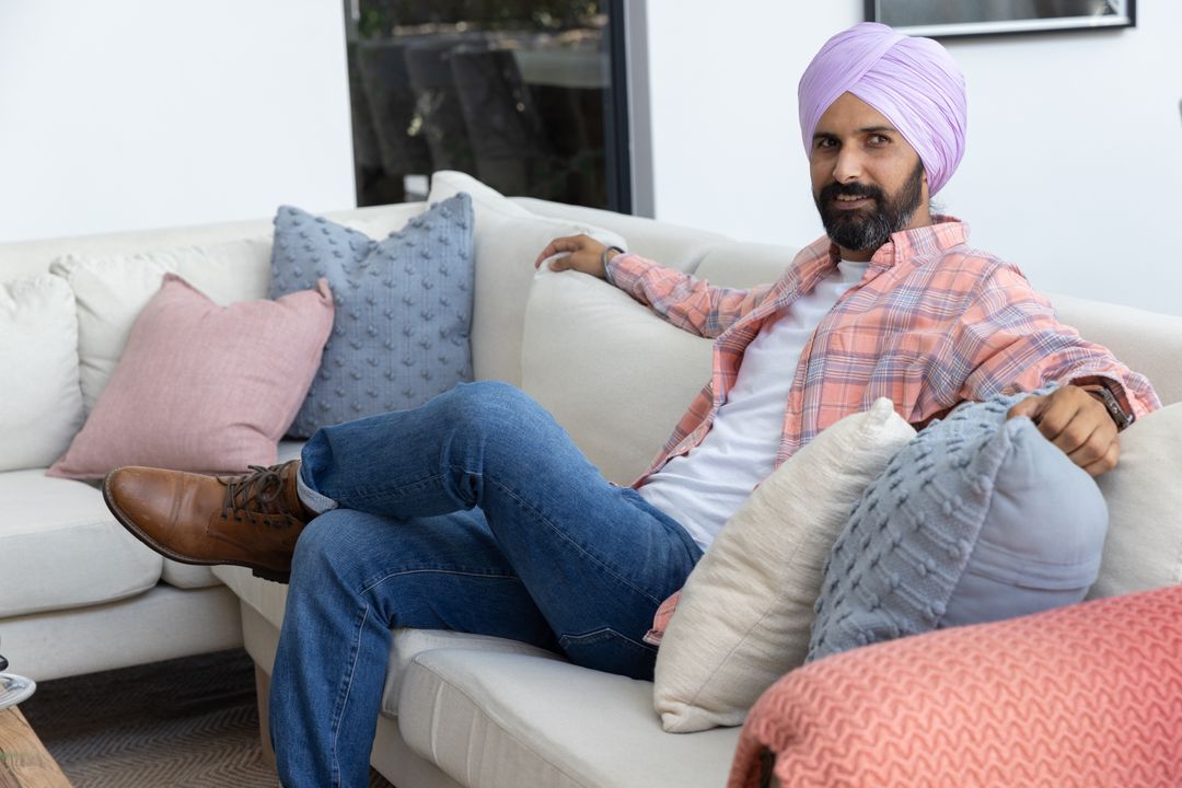 Indian Man Relaxing on Cozy Sofa at Contemporary Home