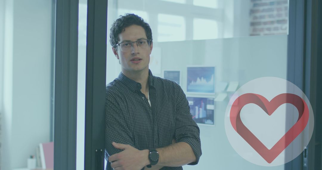 Confident Businessman Smiling in Modern Office with Heart Icon Overlay