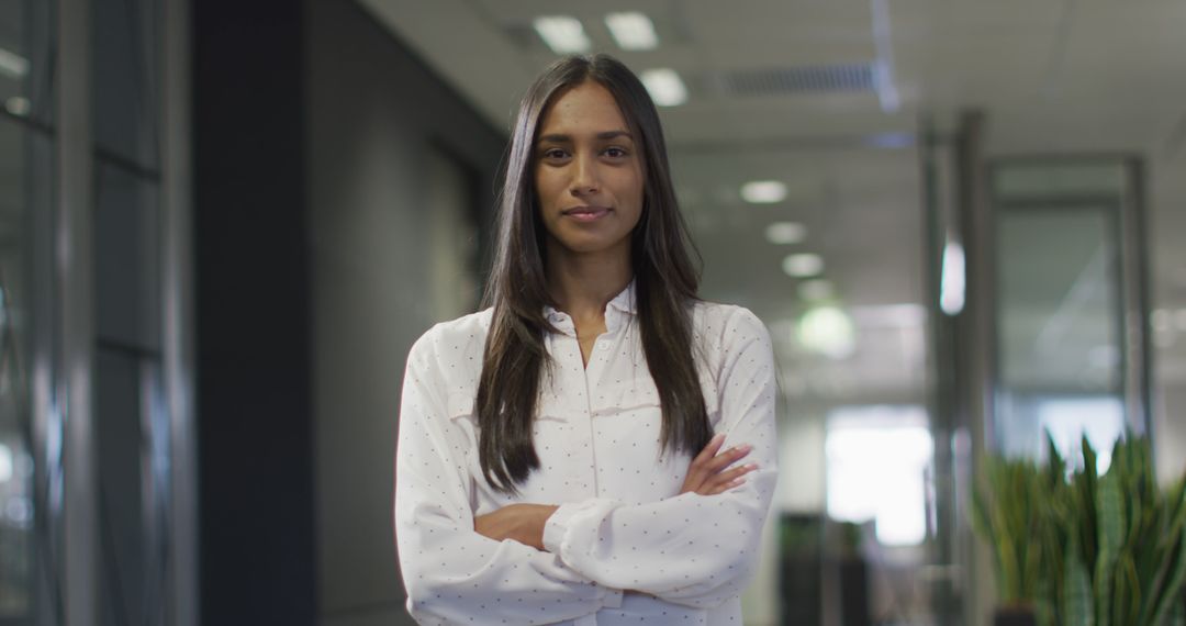 Image of happy biracial woman looking at camera in office - Free Images, Stock Photos and Pictures on Pikwizard.com