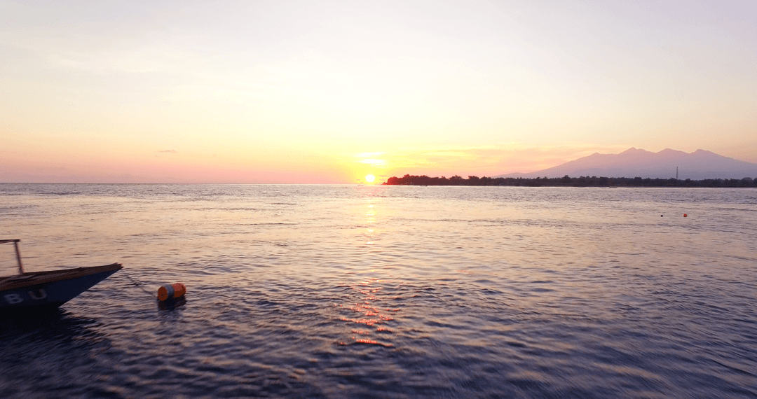 Idyllic Ocean Sunset with Transparent Sky and Gentle Waves