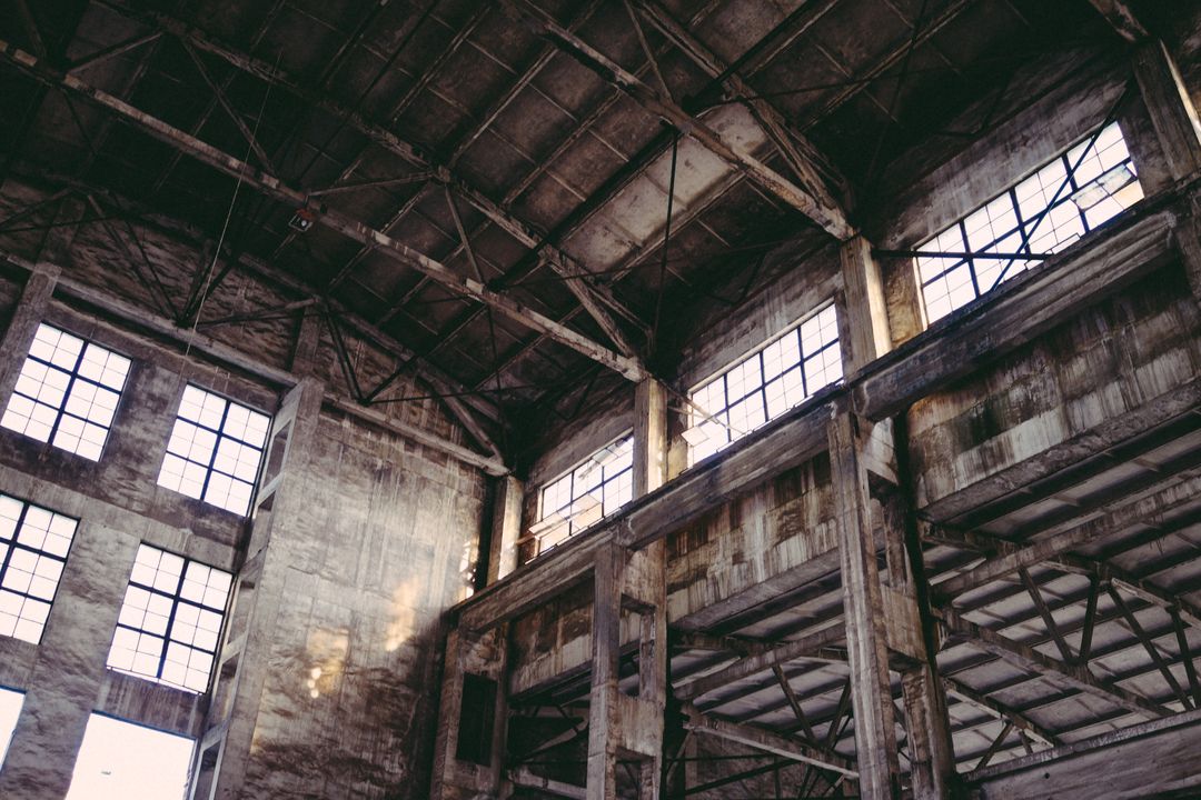 Abandoned Industrial Warehouse with Rustic Windows and Metal Framework - Free Images, Stock Photos and Pictures on Pikwizard.com