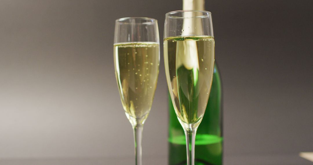 Image of champagne in glasses and bottle on grey background - Free Images, Stock Photos and Pictures on Pikwizard.com