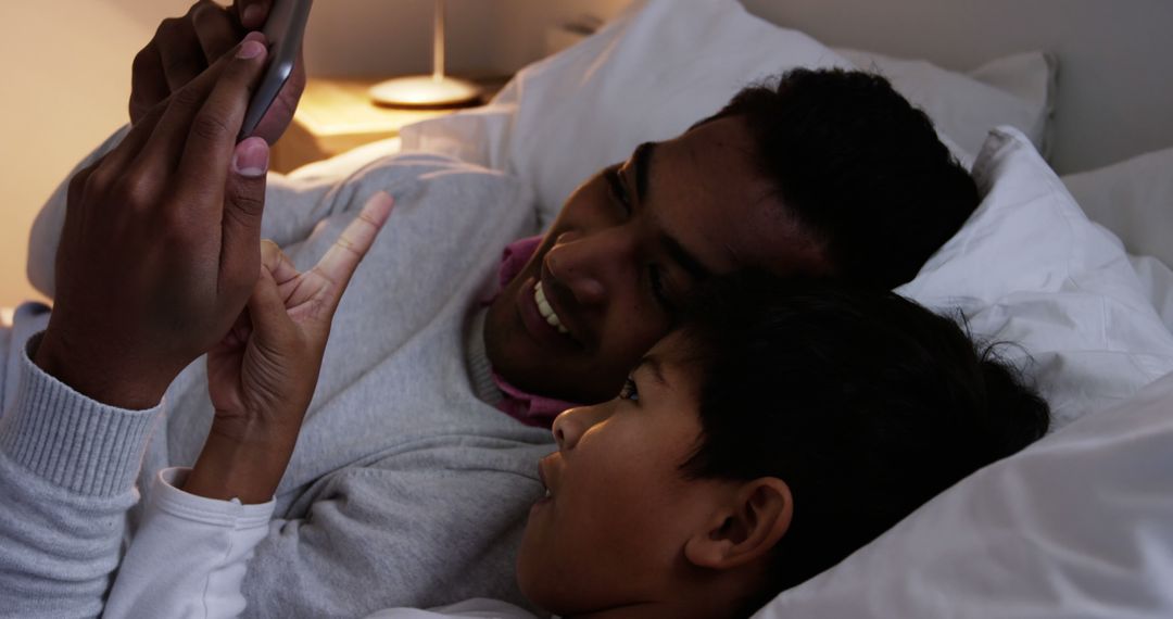 Father and Son Bonding with Tablet in Cozy Bedroom