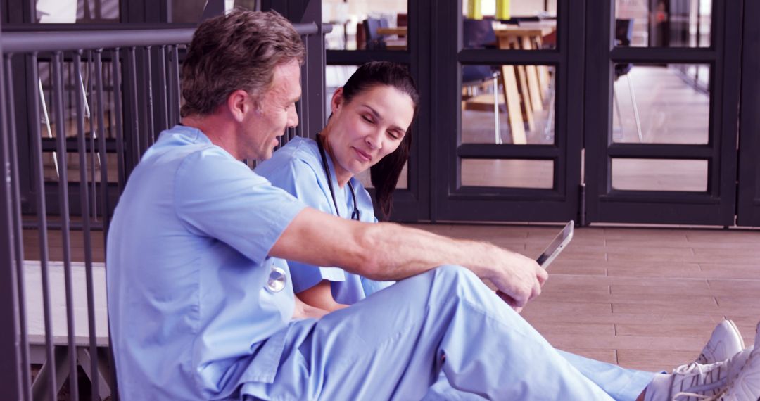 Healthcare professionals taking a break in hospital corridor - Free Images, Stock Photos and Pictures on Pikwizard.com