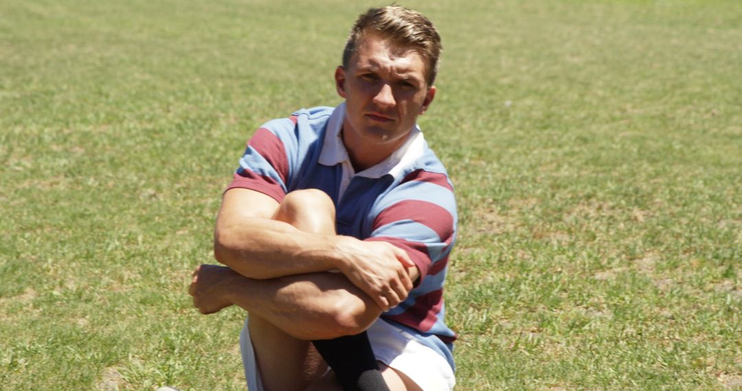 Rugby Player Relaxing is Athletic Grass Field