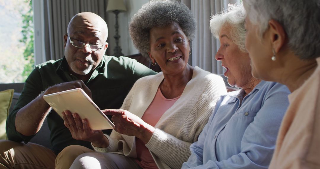 Group of Seniors Using Digital Tablet While Sitting on Couch - Free Images, Stock Photos and Pictures on Pikwizard.com