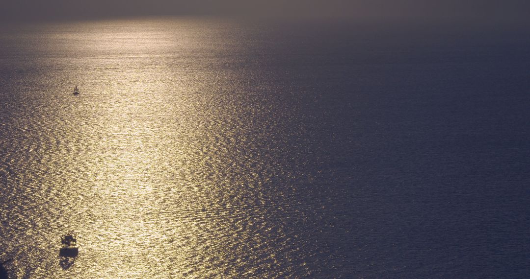 Golden Sunset Over Calm Ocean with Distant Boats Silhouetted - Free Images, Stock Photos and Pictures on Pikwizard.com