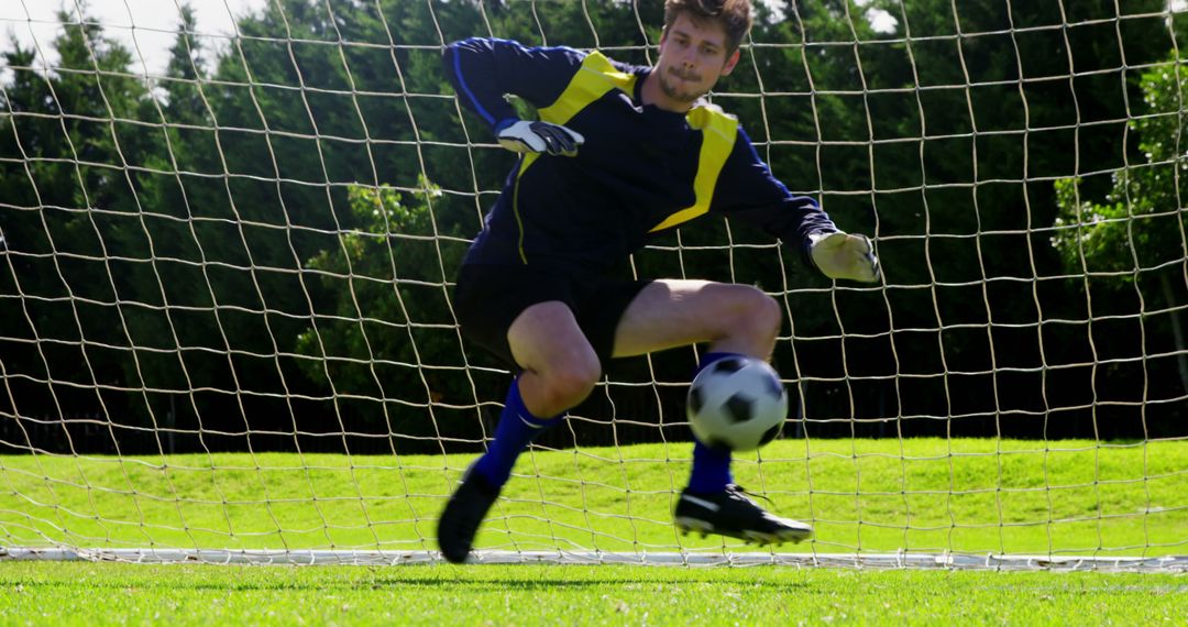 Goalkeeper Making a Save in Soccer Match on Sunny Day - Free Images, Stock Photos and Pictures on Pikwizard.com