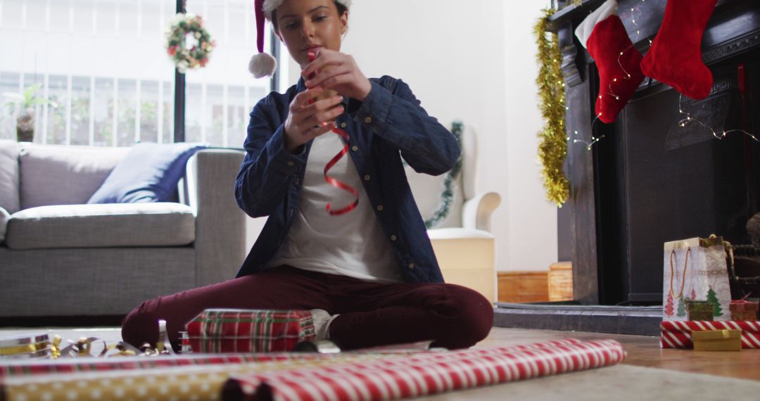 Woman Wrapping Christmas Gifts in Cozy Living Room - Free Images, Stock Photos and Pictures on Pikwizard.com