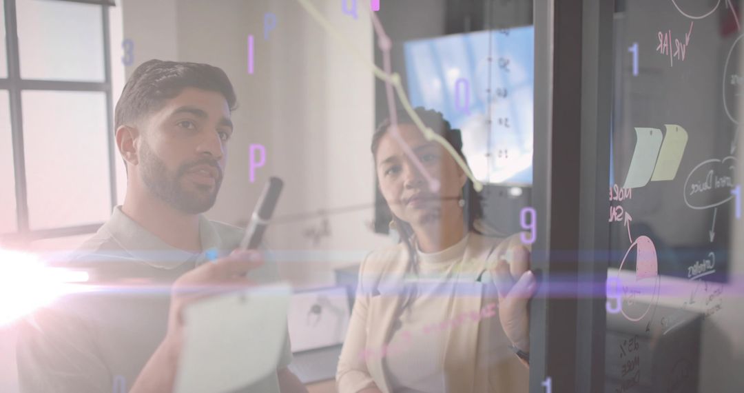 Business Professionals Analyzing Data on Glass Board in Office