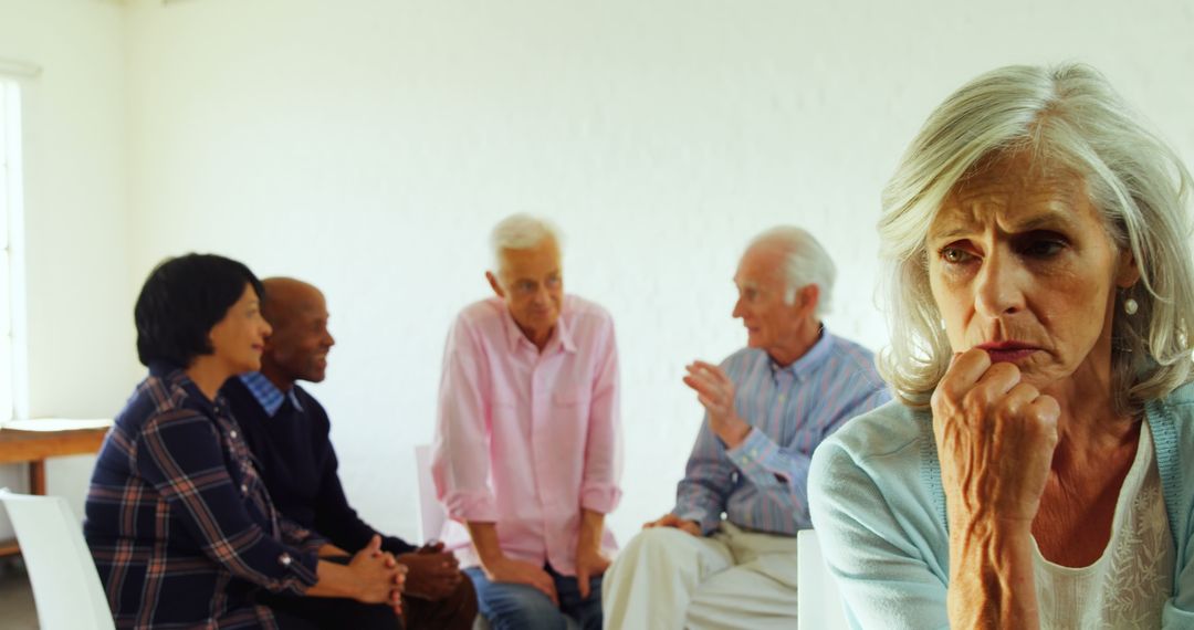 Senior Woman Feeling Isolated in Group Setting - Free Images, Stock Photos and Pictures on Pikwizard.com