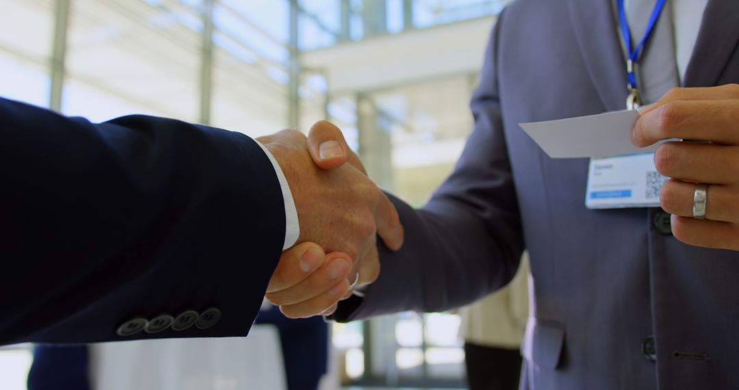 Businesspeople Shaking Hands and Exchanging Cards
