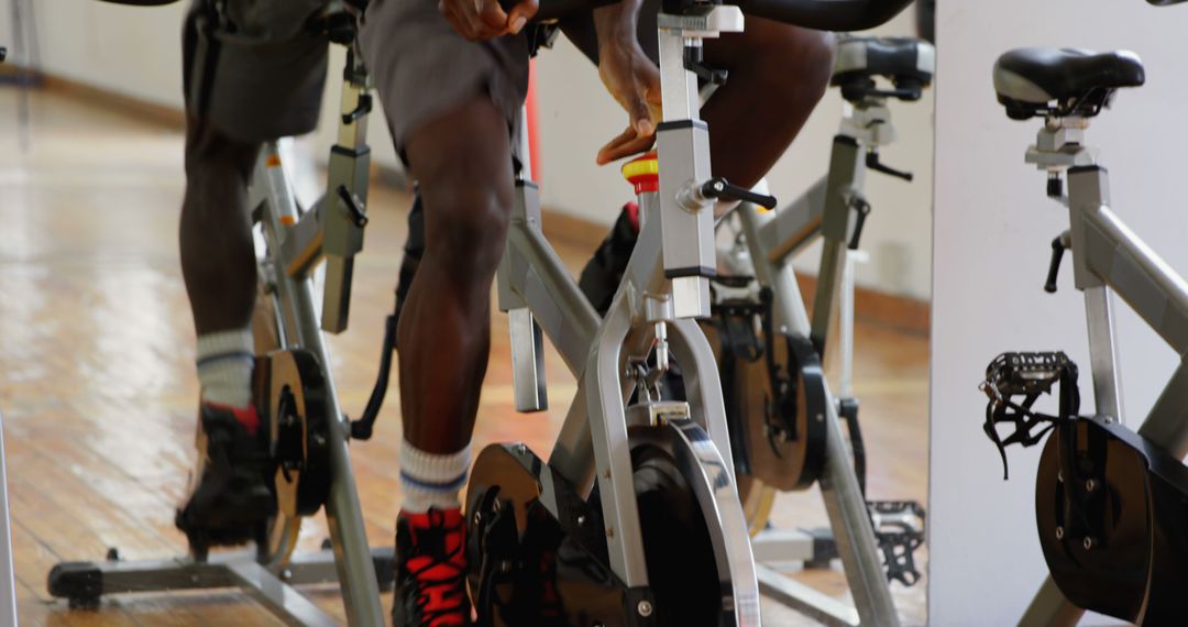 African American Man Exercising on Stationary Bike in Gym - Free Images, Stock Photos and Pictures on Pikwizard.com