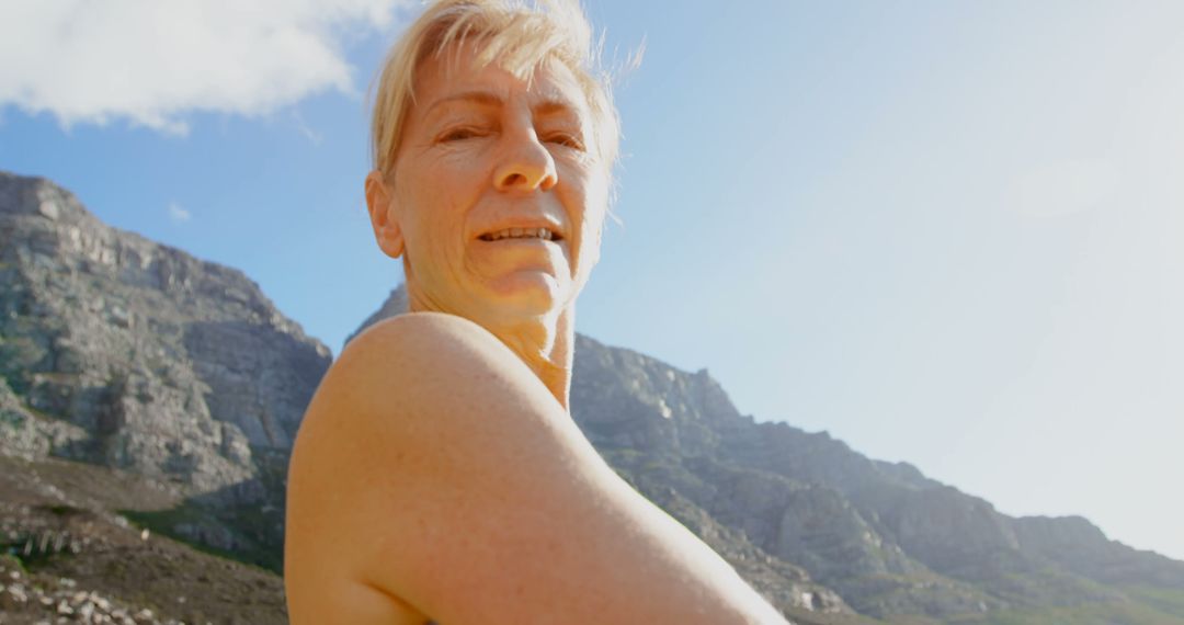 Senior Woman Exercising Outdoors in Mountain Landscape - Free Images, Stock Photos and Pictures on Pikwizard.com