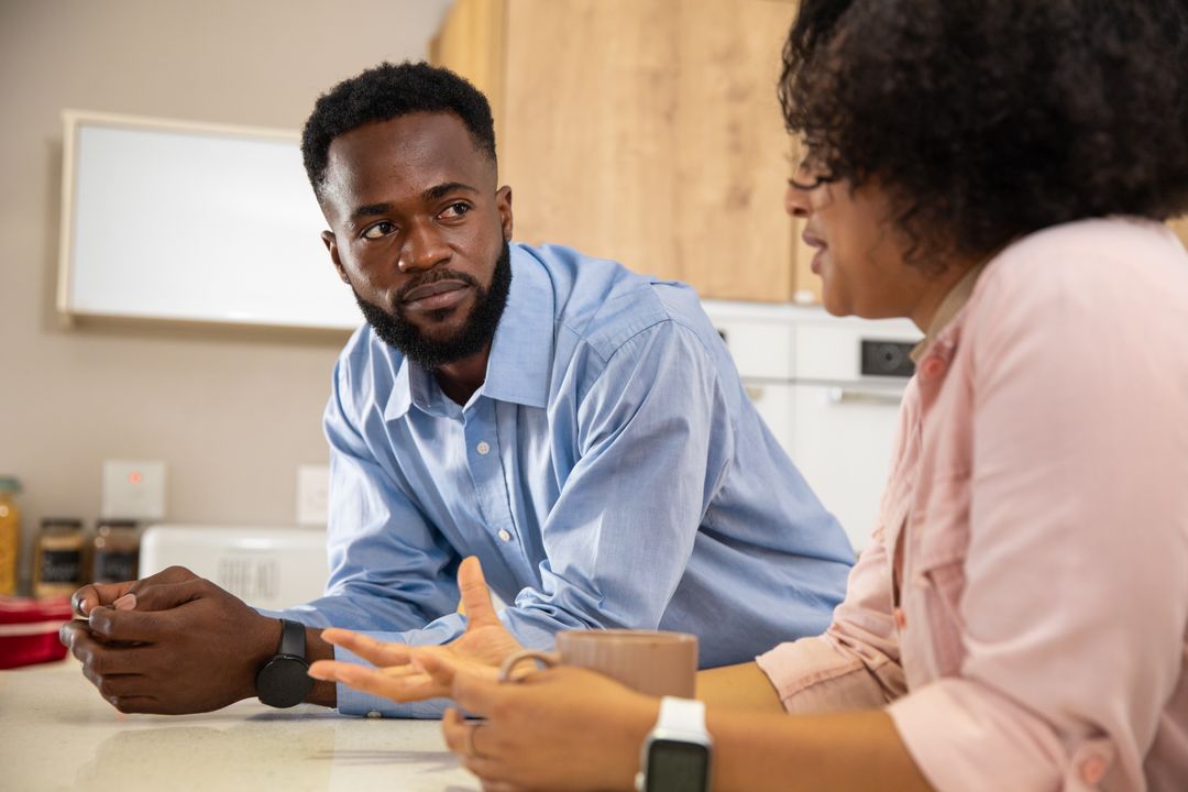 Couple Engaging in Conversation at Modern Kitchen Counter