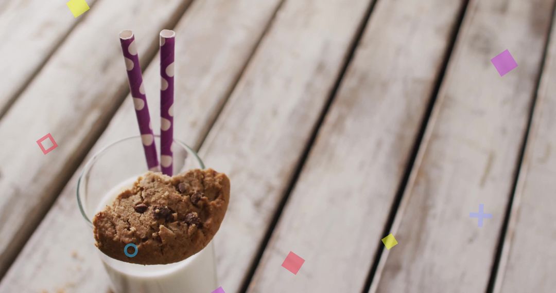 Glass of Milk with Cookie and Straws on Rustic Table