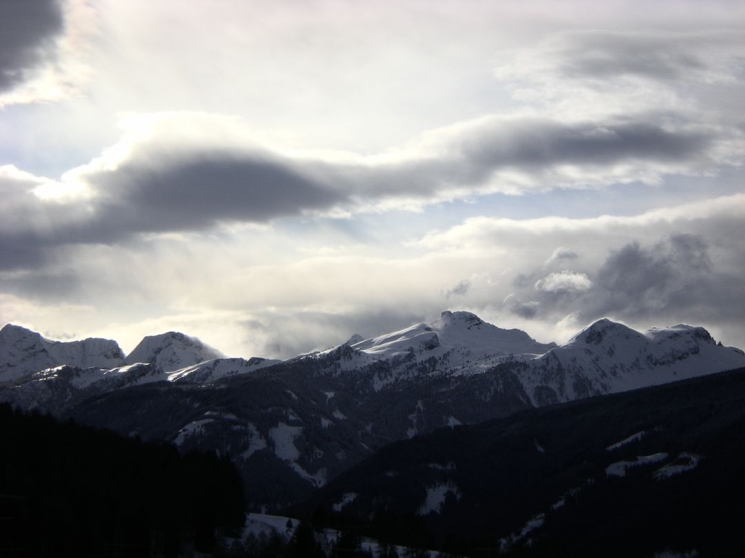 Dramatic Cloudy Sky Over Snow-Capped Mountain Range - Free Images, Stock Photos and Pictures on Pikwizard.com