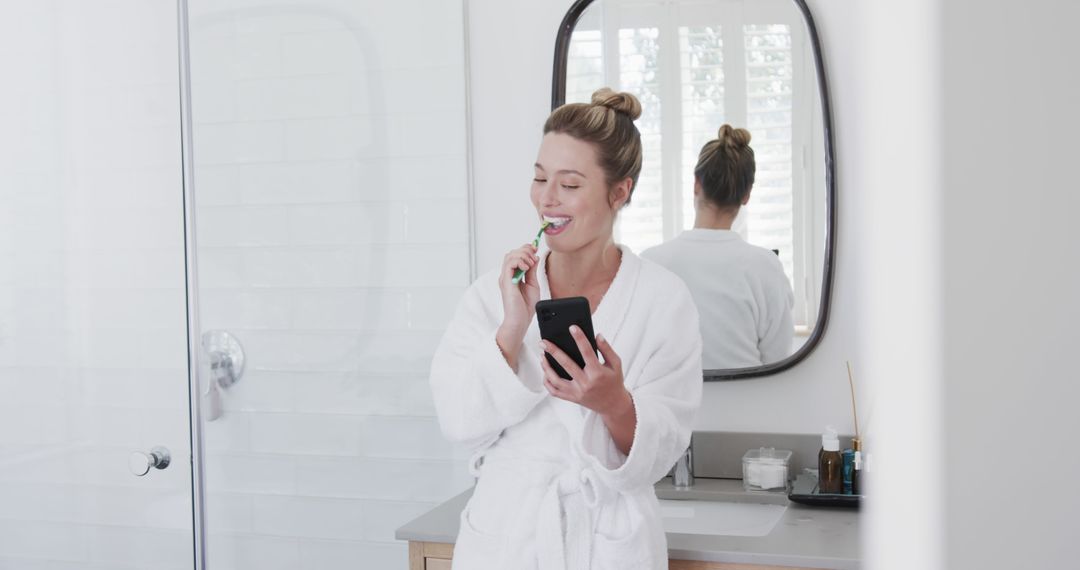 Woman Brushing Teeth in Bathroom Using Smartphone - Free Images, Stock Photos and Pictures on Pikwizard.com