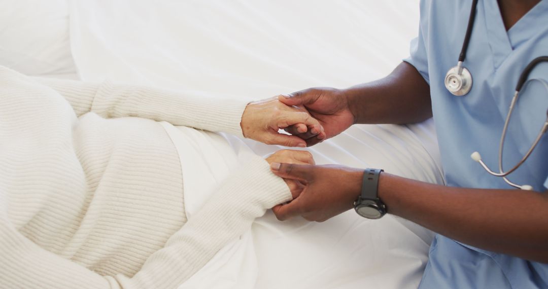 Image of hands of african american male doctor holding caucasian senior woman - Free Images, Stock Photos and Pictures on Pikwizard.com