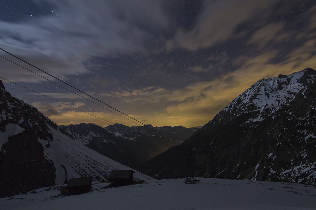 Nighttime Mountain Landscape with Snow and Cloudy Sky - Free Images, Stock Photos and Pictures on Pikwizard.com