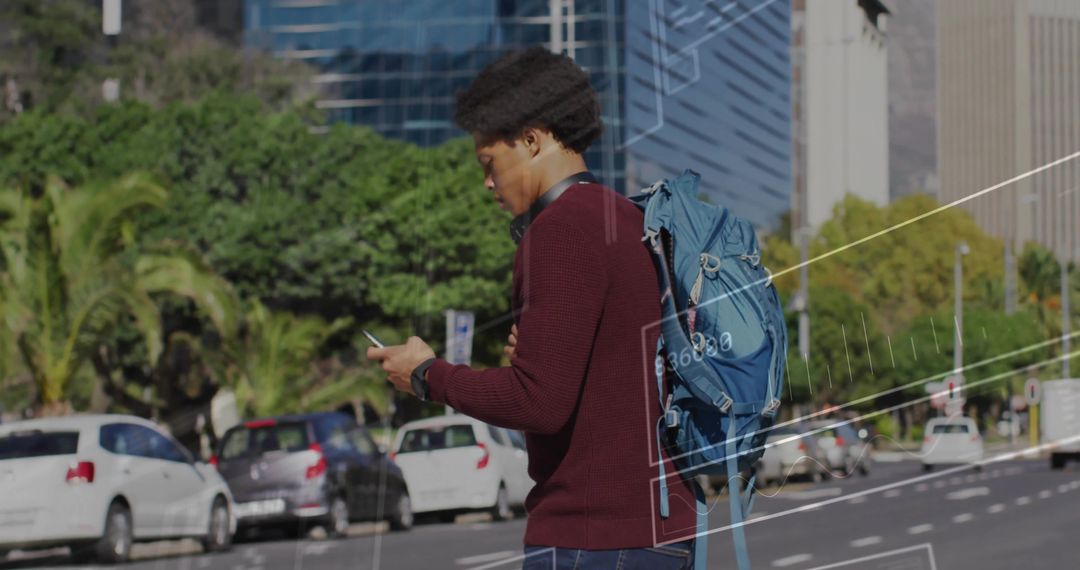 Young Man Walking in Urban Setting Checking Smartphone