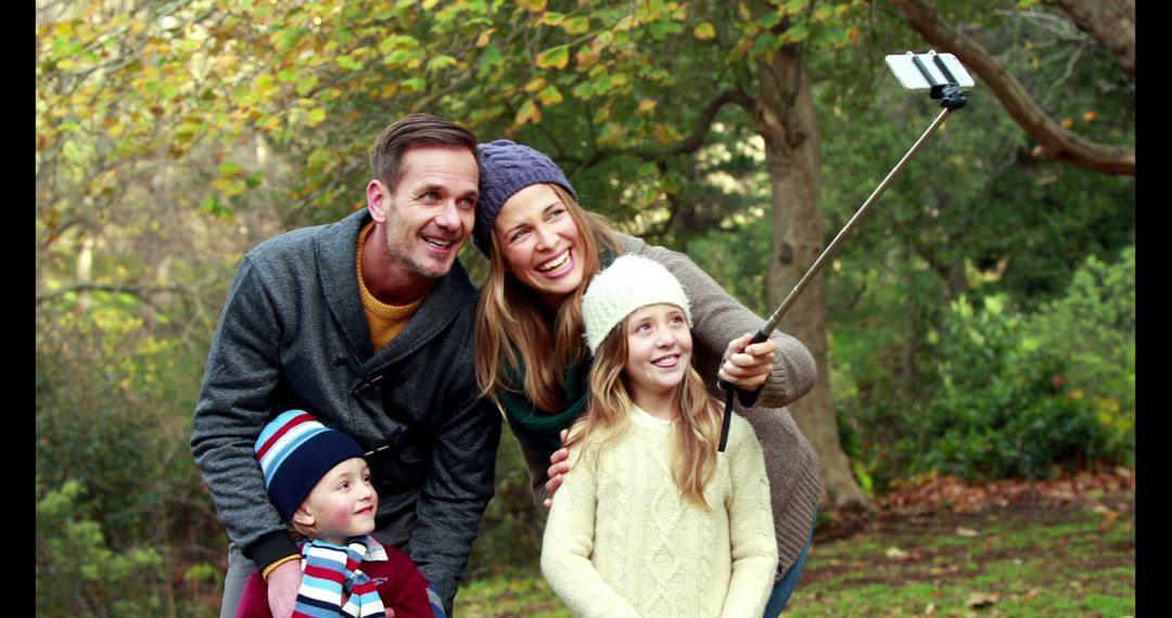 Happy Family Taking Selfie in Park During Autumn - Free Images, Stock Photos and Pictures on Pikwizard.com