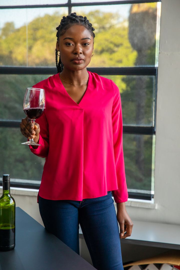 Woman Relaxing with Wine Glass Enjoying Scenic View by Window