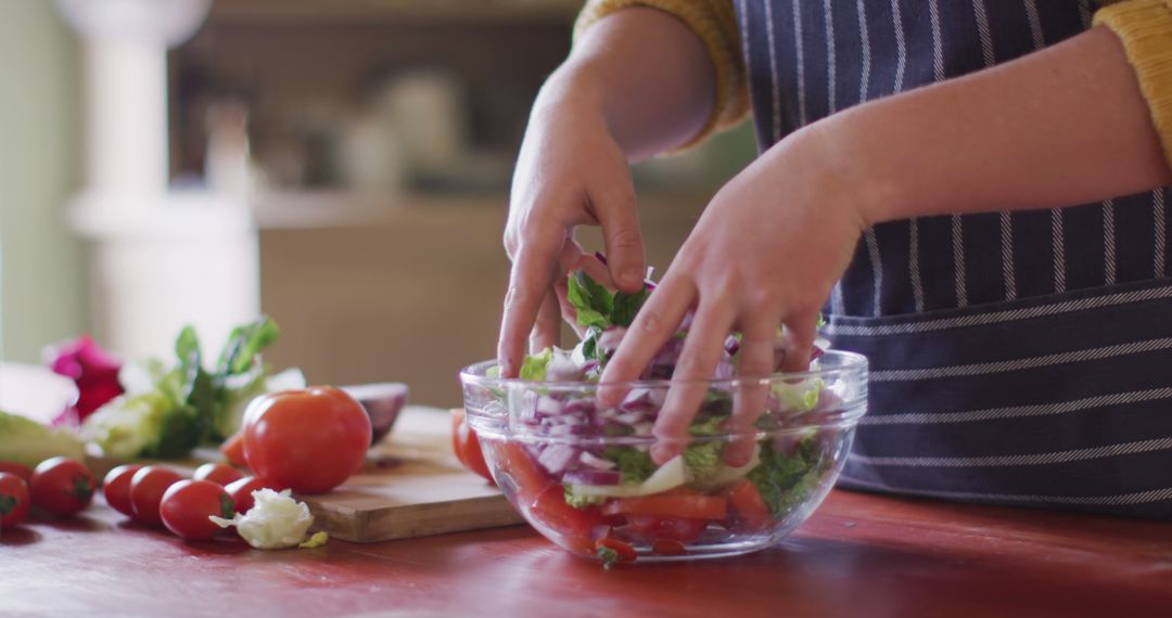 Person Making Fresh Vegetable Salad in Kitchen - Free Images, Stock Photos and Pictures on Pikwizard.com