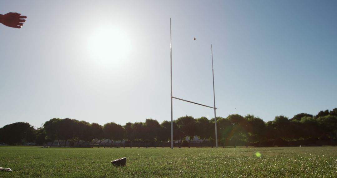 Rugby Kick Attempt towards Goal Posts on Sunny Day - Free Images, Stock Photos and Pictures on Pikwizard.com