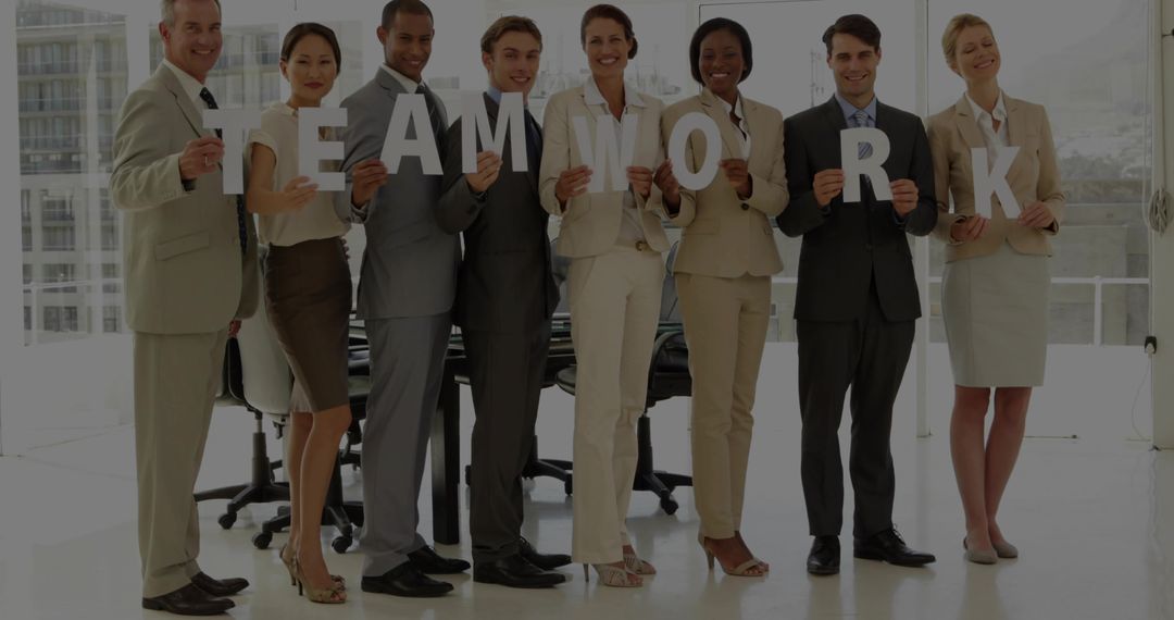 Corporate Team Holding TEAMWORK Letters in Bright Office, Collaboration Focus for Business