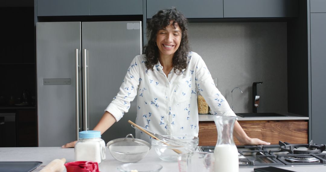 Smiling Woman Relaxing in Modern Kitchen While Baking - Free Images, Stock Photos and Pictures on Pikwizard.com