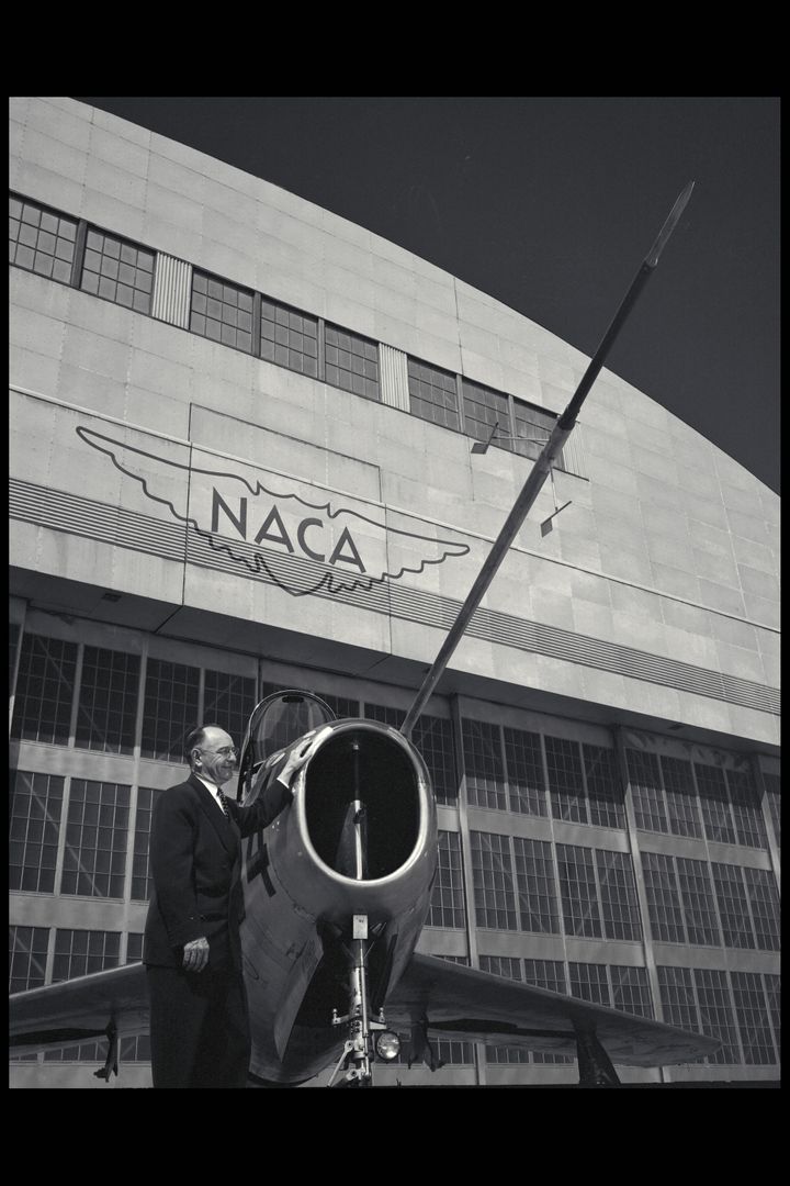 Man Standing Next to F-84 Aircraft Outside NACA Hangar - Free Images, Stock Photos and Pictures on Pikwizard.com