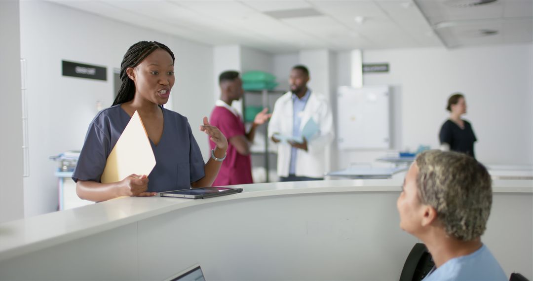 Nurse Discussing Patient Care in Hospital Reception Area - Free Images, Stock Photos and Pictures on Pikwizard.com