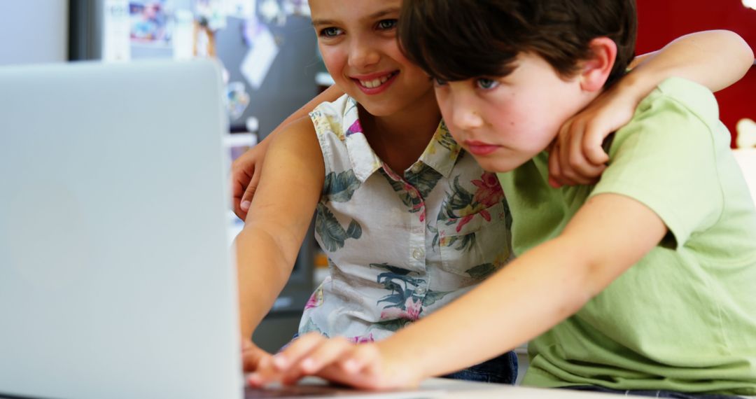 Engaged Young Children Exploring Educational Content on Laptop