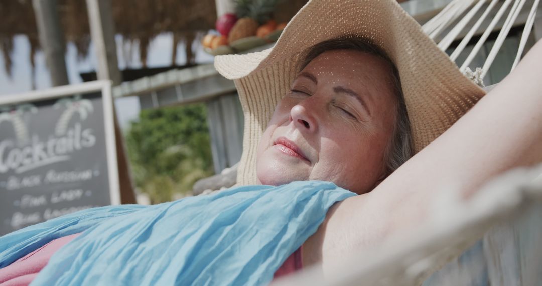 Senior Woman Relaxing on Hammock at Beach Resort - Free Images, Stock Photos and Pictures on Pikwizard.com