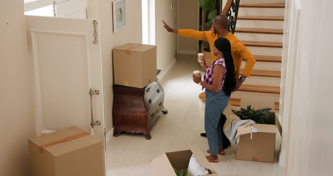 Couple Embracing New Home with Moving Boxes and Joyful Anticipation
