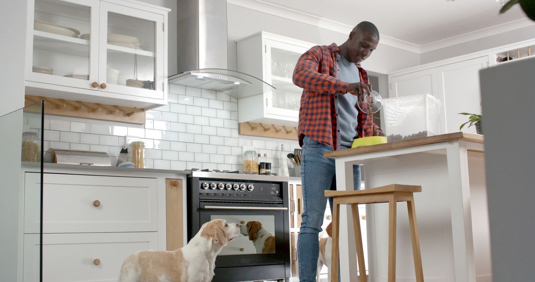 Man Preparing Dog Food in Modern Kitchen with Pet Watching - Free Images, Stock Photos and Pictures on Pikwizard.com