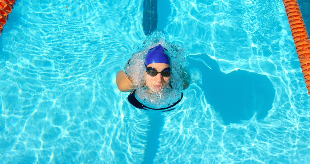 Female Swimmer in Pool Wearing Goggles and Cap During Practice - Free Images, Stock Photos and Pictures on Pikwizard.com