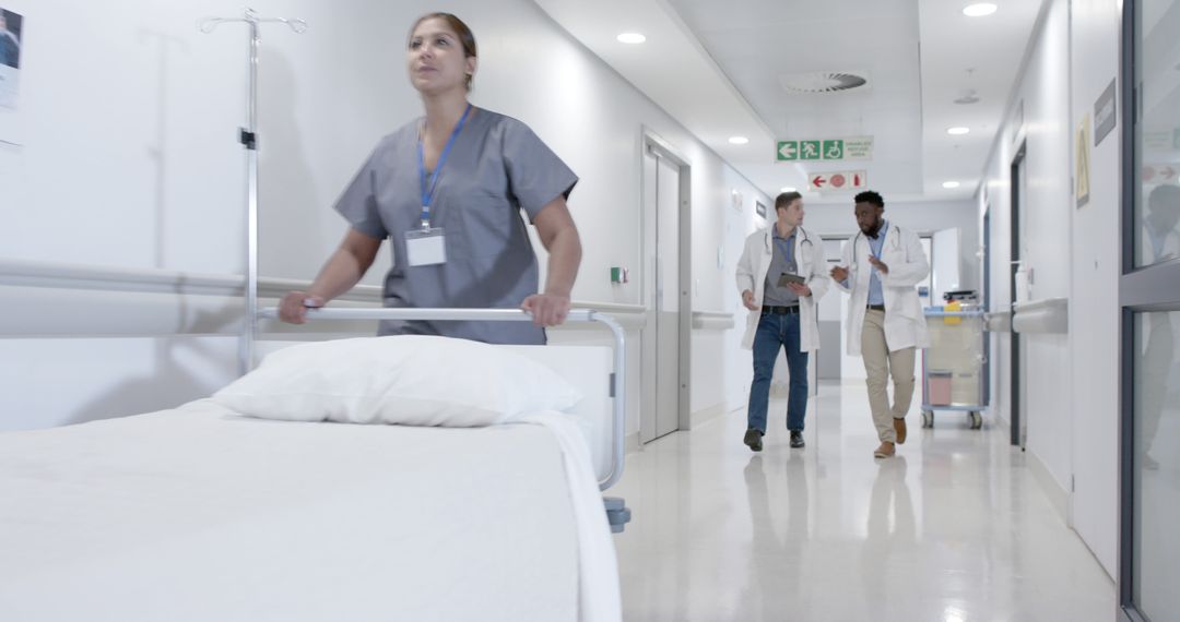 Hospital Staff and Doctors Walking in Modern Medical Facility Corridor - Free Images, Stock Photos and Pictures on Pikwizard.com