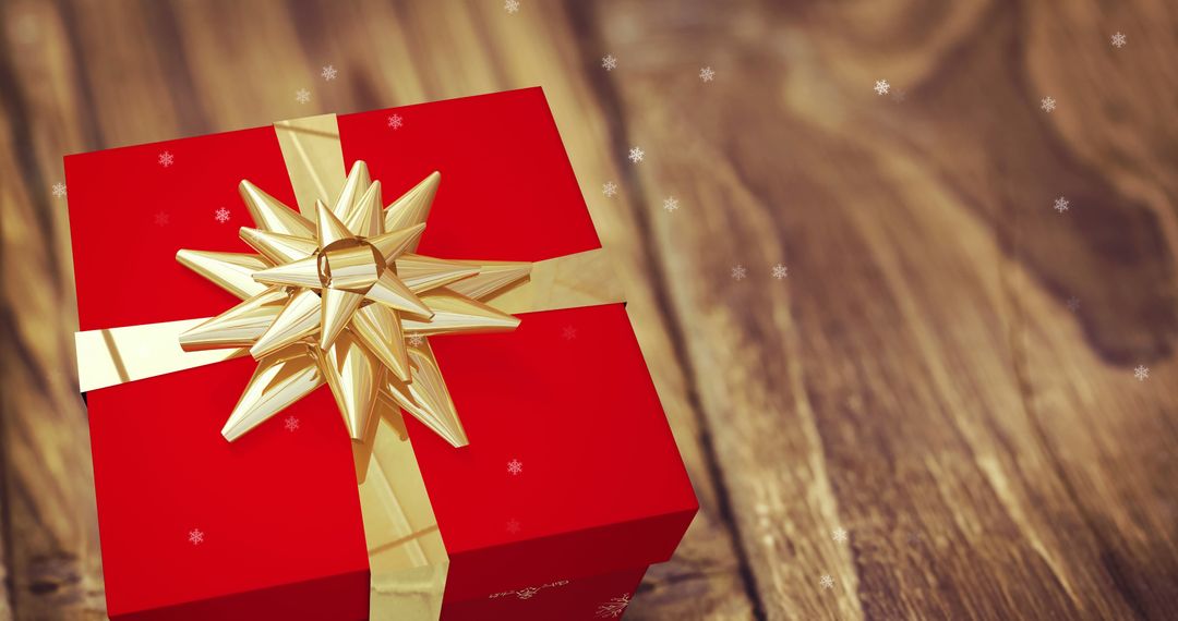 Festive Red Gift Box with Gold Bow and Falling Snowflakes