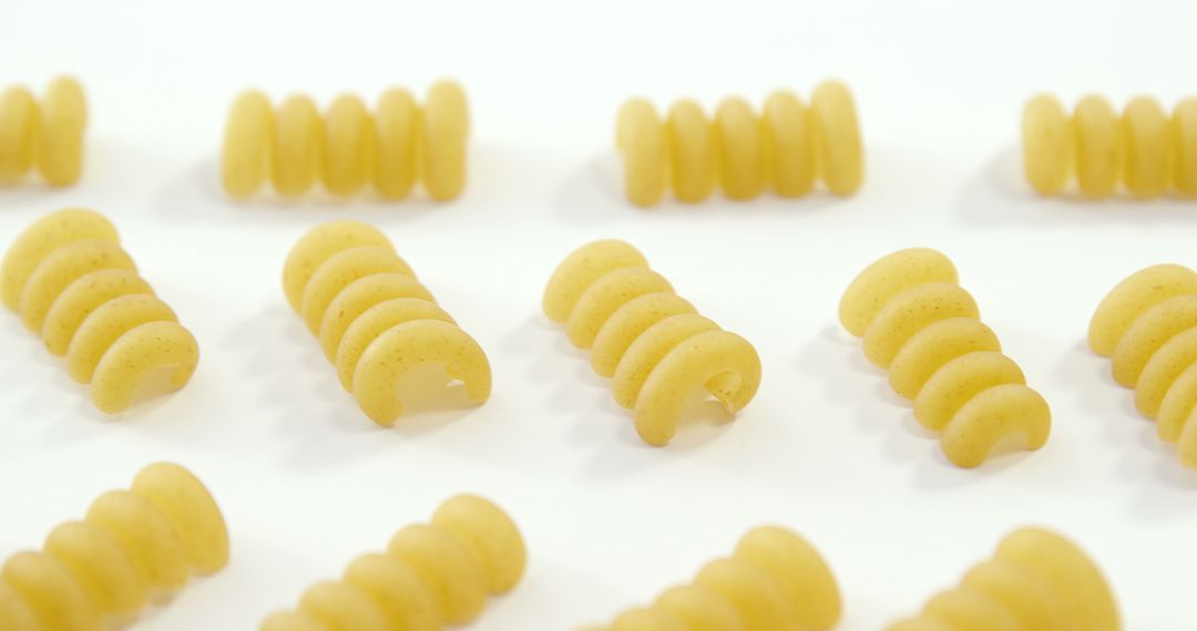 Raw Spiral Pasta Arranged in Rows on White Background - Free Images, Stock Photos and Pictures on Pikwizard.com