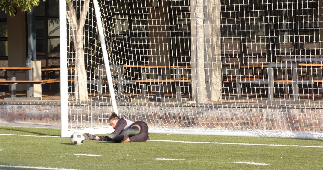 Goalkeeper Diving to Save Soccer Ball