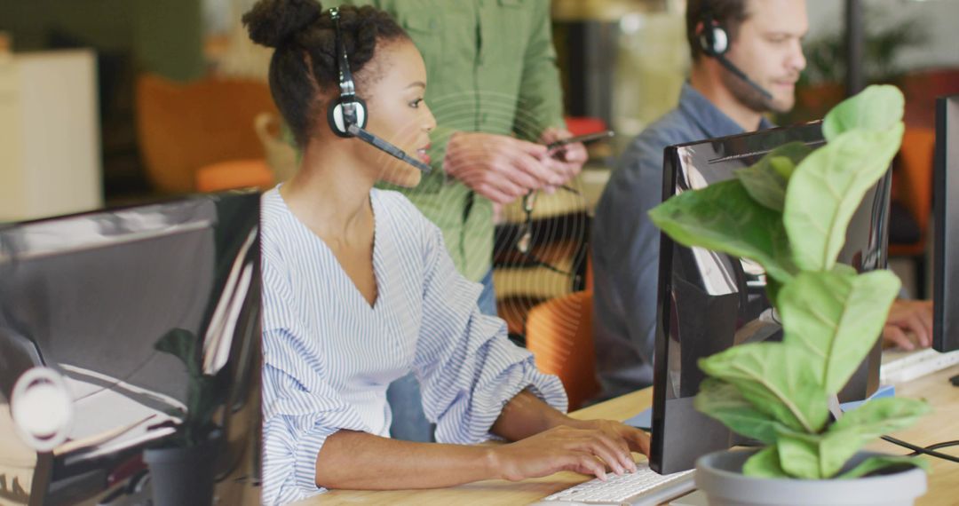 Customer Support Teams Working Collaboratively in Office with headsets