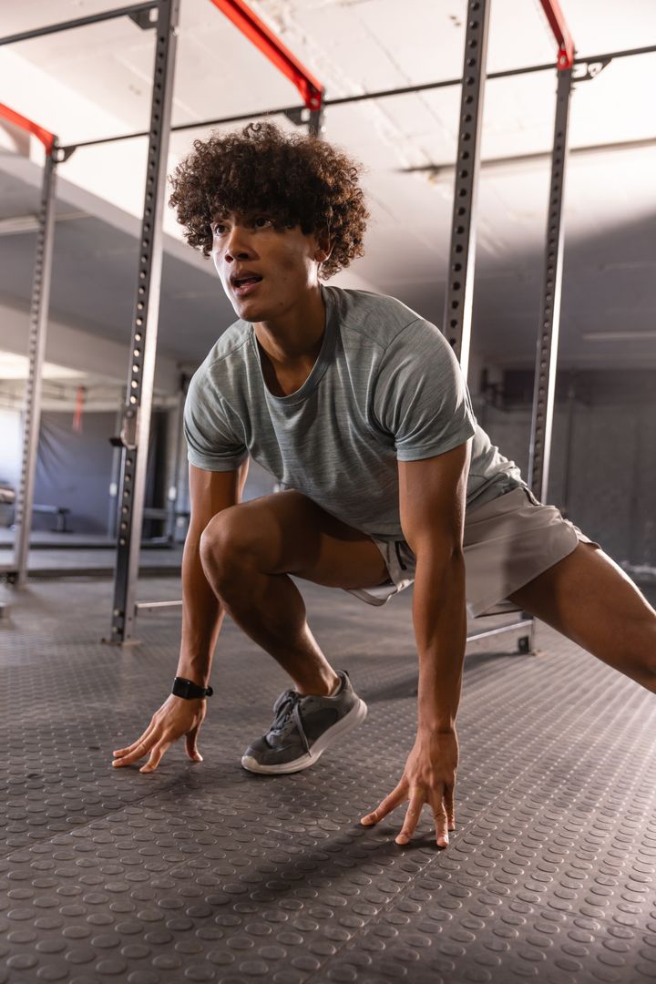 Determined Athlete Engaged in Lunging Exercise in Modern Gym