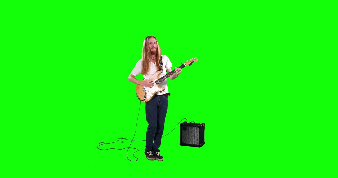 Man Playing Electric Guitar with Amp on Green Screen Background - Free Images, Stock Photos and Pictures on Pikwizard.com