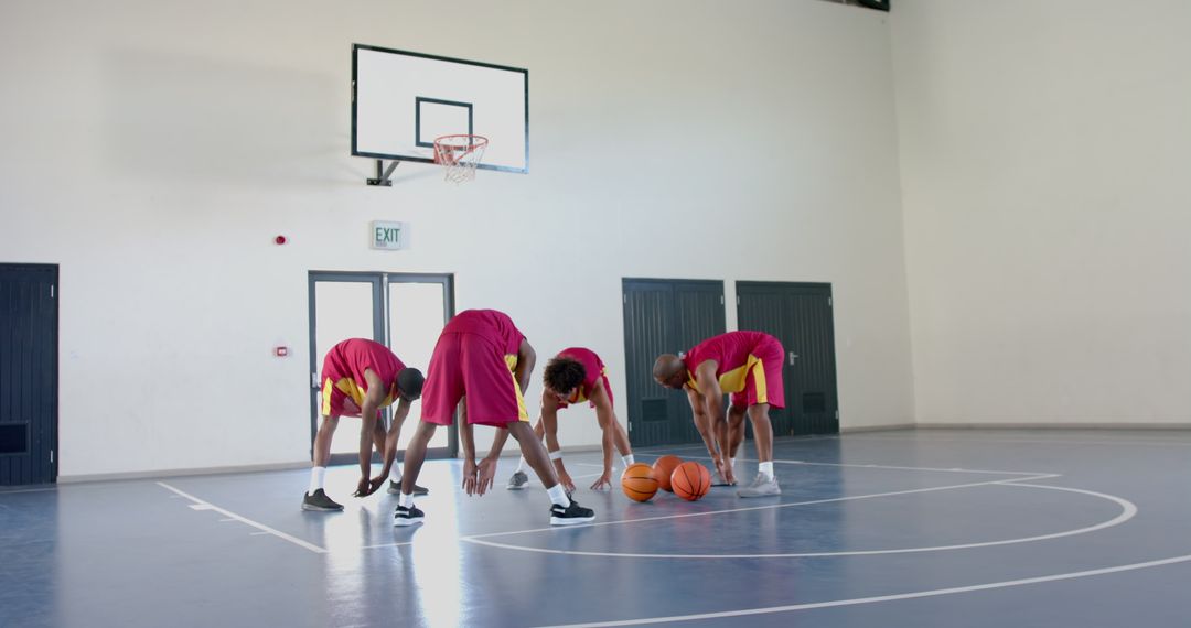 Diverse Basketball Team Practicing Skills in Indoor Court