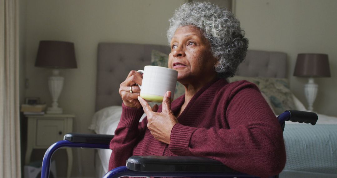 Senior African American Woman Sitting in Wheelchair Holding Coffee Mug - Free Images, Stock Photos and Pictures on Pikwizard.com